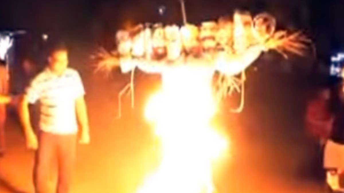 NSUI students burning Ravana effigy with PM Narendra Modi and Amit Shah as two faces NSUI students burning Ravana effigy with PM Narendra Modi and Amit Shah as two faces