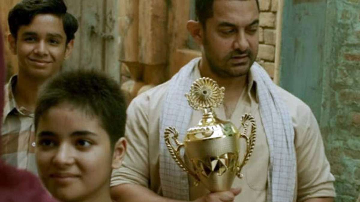 Dangal Box Office collection: Aamir Khan holding trophy in the film Dangal Box Office collection: Aamir Khan holding trophy in the film