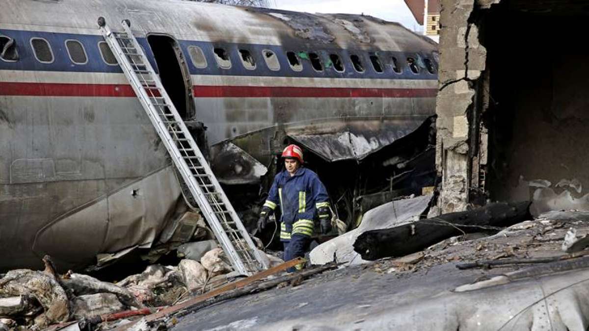 An Iranian rescue worker at the site of a Boeing 707 cargo plane crash, at Fath Airport about 40 kilometers (25 miles) west of Tehran, Iran, Monday, Jan. 14, 2019. An Iranian rescue worker at the site of a Boeing 707 cargo plane crash, at Fath Airport about 40 kilometers (25 miles) west of Tehran, Iran, Monday, Jan. 14, 2019.
