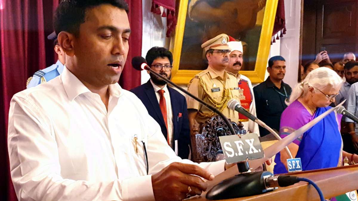 Goa Governor Mridula Sinha (R) administers the oath of the office to Pramod Sawant as the new Chief Minister of the state, at the Raj Bhavan in Panaji on Tuesday (PTI) Goa Governor Mridula Sinha (R) administers the oath of the office to Pramod Sawant as the new Chief Minister of the state, at the Raj Bhavan in Panaji on Tuesday (PTI)