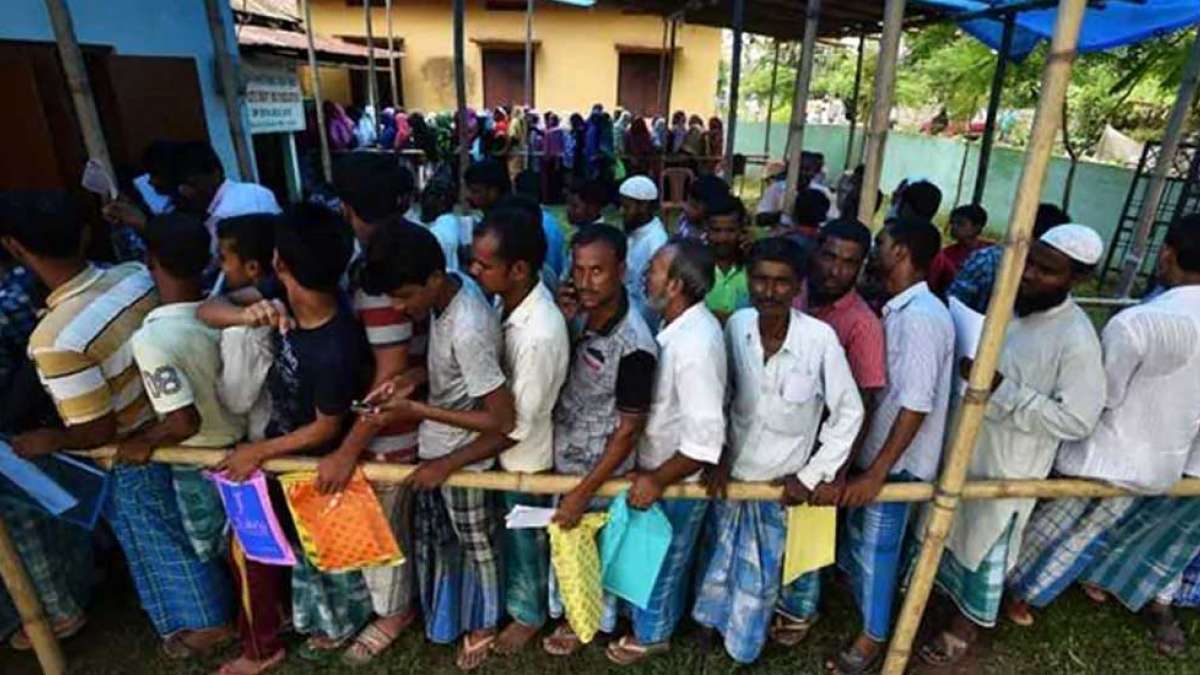 People standing in que for NRC registration People standing in que for NRC registration