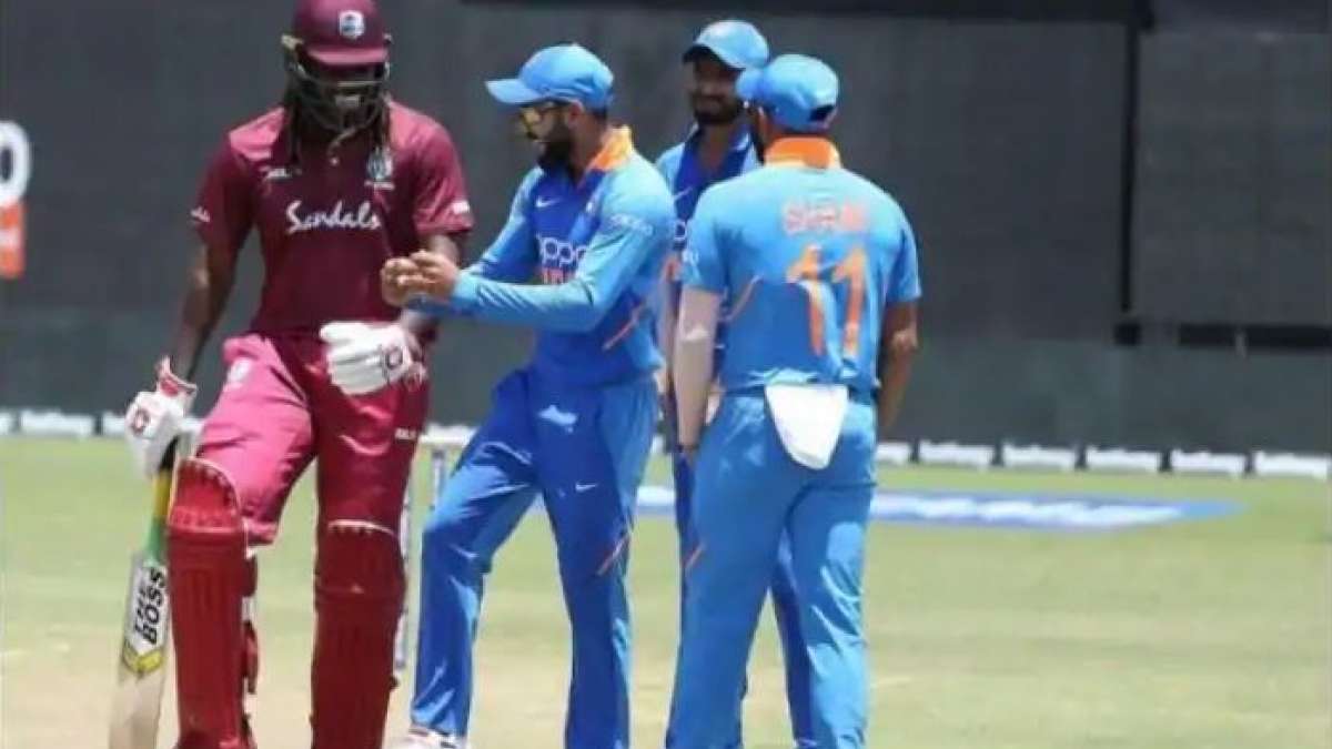 Virat Kohli shakes a leg with Chris Gayle on field Virat Kohli shakes a leg with Chris Gayle on field